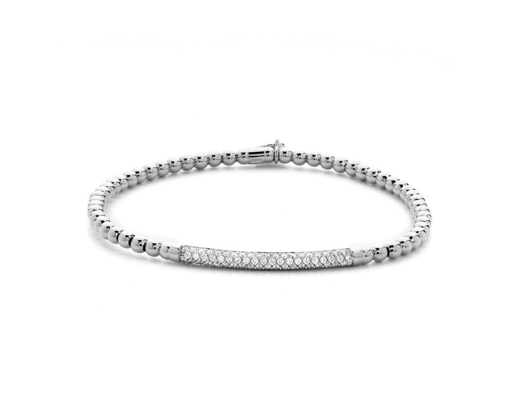 A white gold bracelet laid flat on a white background. The bracelet features silver beads and a diamond clustered bar station in the middle.