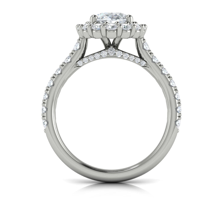 A top view of a white gold engagement ring is set against a white background. The engagement ring features an oval center diamond, a cathedral setting, a diamond-set halo, and a diamond-set band.