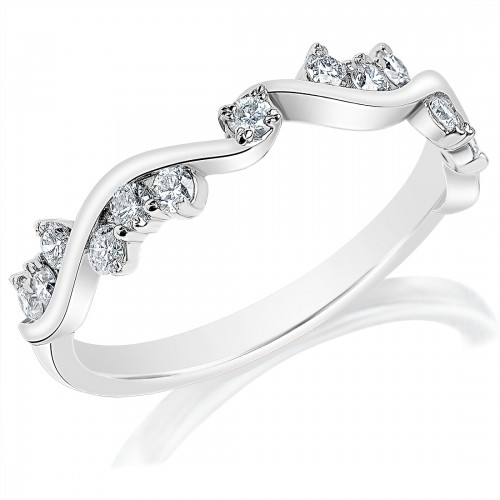 An angled view of a white gold wedding band against a white background. The ring features a wavy band with clusters of diamonds nestled inside the troughs.