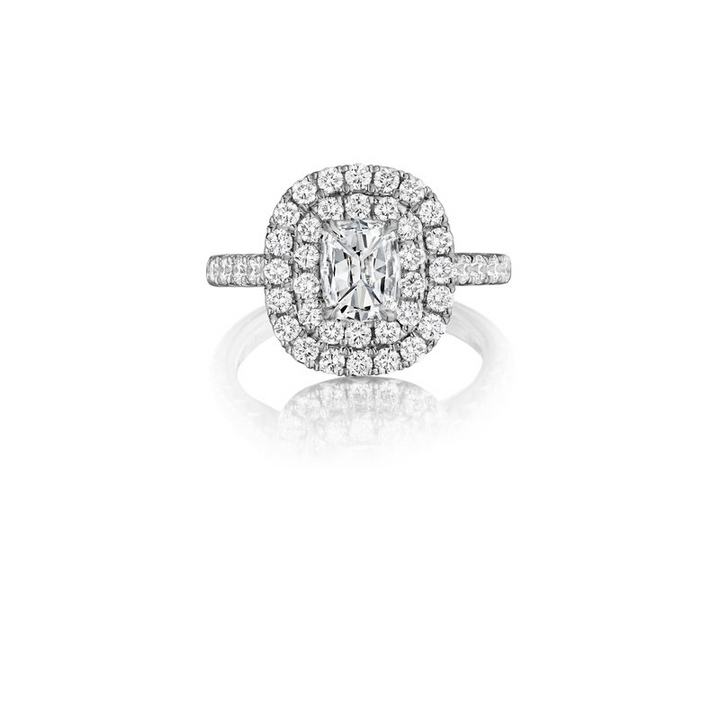 This is a front view of a white gold ring against a white background. The ring features a brilliant center stone embraced by two dazzling halos of diamonds.