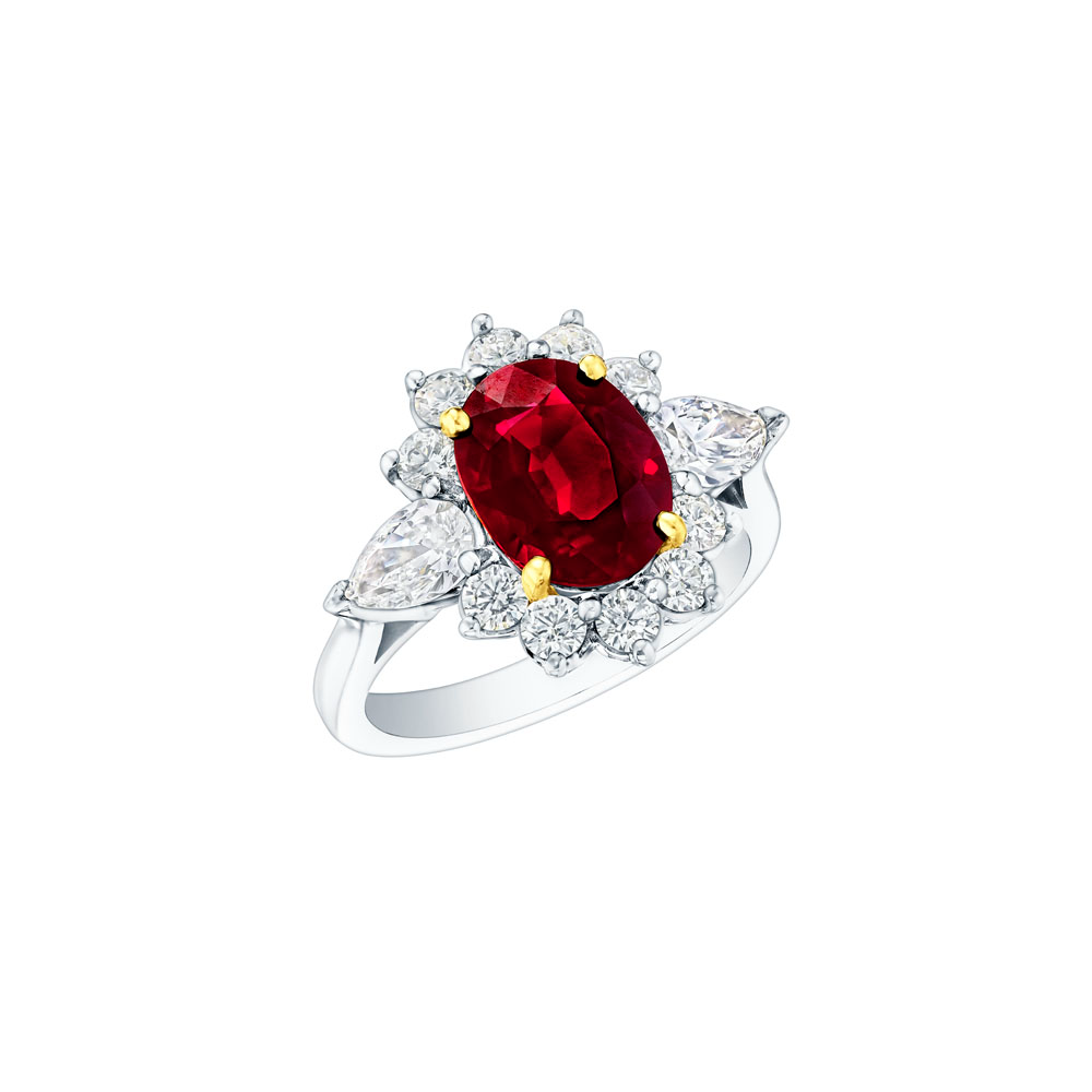 A white gold ring angled to the left in the middle of a white background. The ring features an oval-shaped ruby center stone with gold prongs, two marquise-shaped diamonds, and 10 round-shaped diamonds.