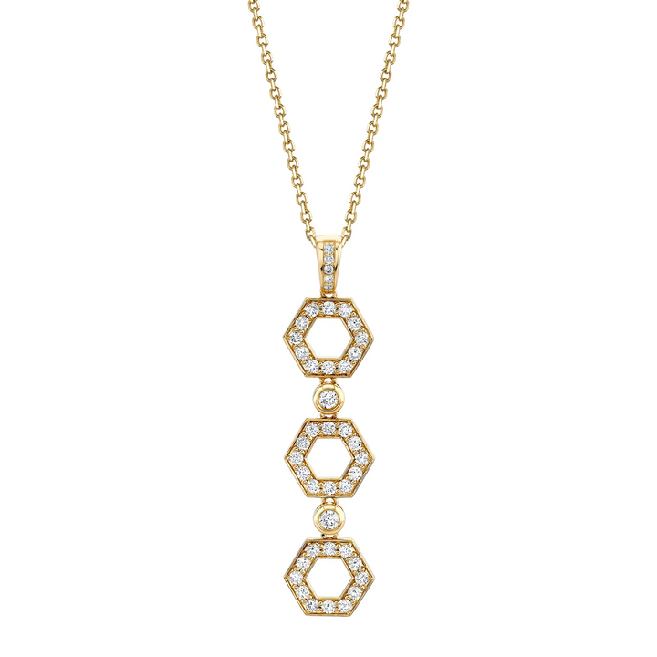 A front view of a yellow gold diamond pendant necklace against a white background. The ring features a drop design with shaped hexagons connected by round bezel-set diamonds.
