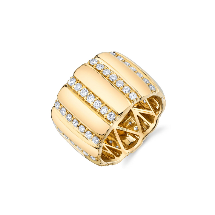 A yellow-gold ring lying flat against a white background. The ring features a wide cigar band with rows of pave-set round diamonds.