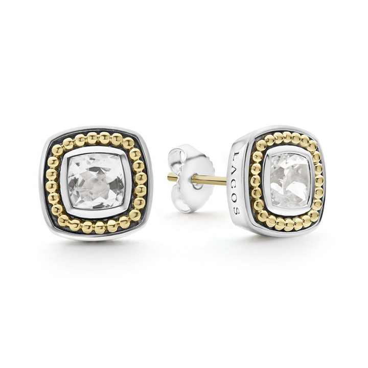 A pair of stud earrings with a White topaz gemstone surrounded by sterling silver and 18k gold Caviar beading. The right earring is angled to the side, showing the back.