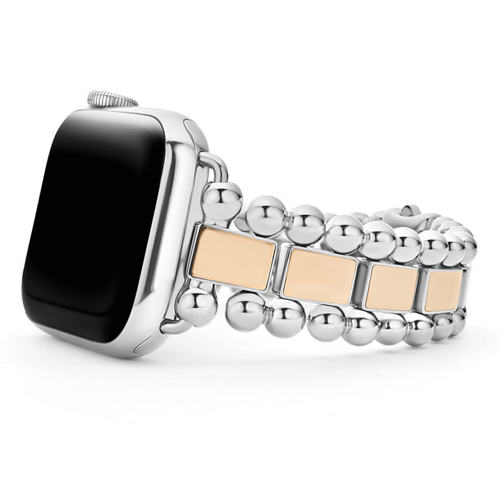 An Apple watch resting on its left side against a white background. The watch band features 18K rose-gold stationed links and stainless steel beading around the links.