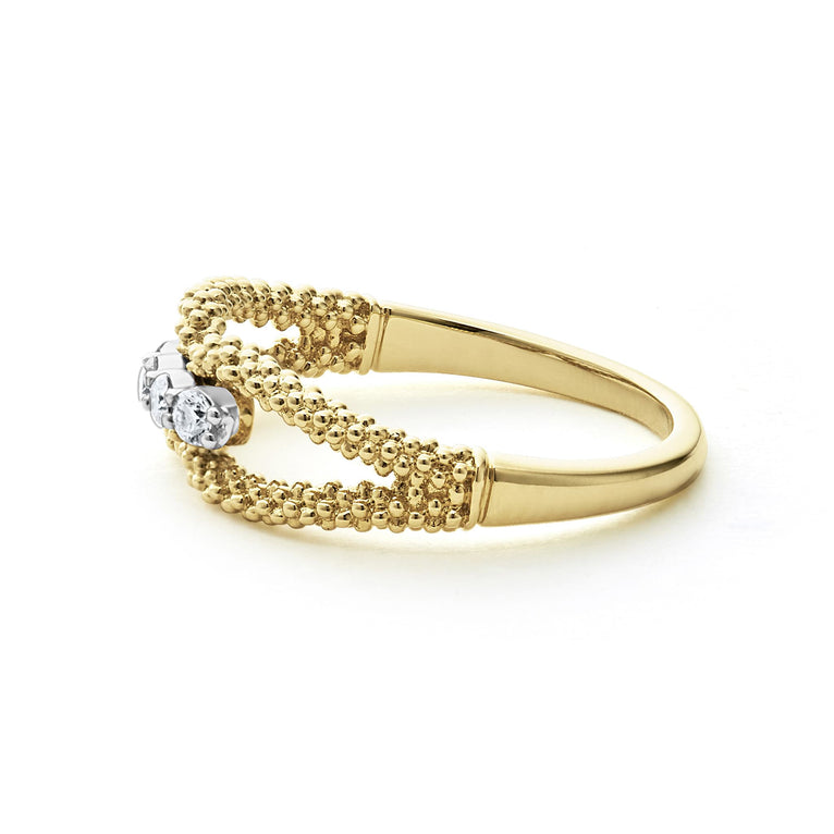 A side-view of An 18K Gold ring in the middle of a white background featuring caviar beading and round diamonds set in the center.