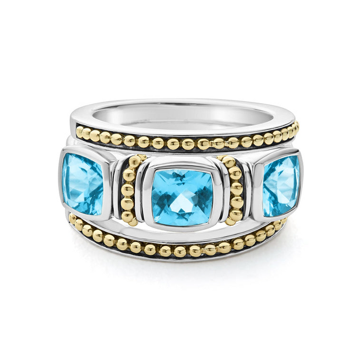 A side-view of a sterling silver and 18k gold ring displayed in the middle of a white background featuring a trio of stacking rings with one swiss blue topaz ring and two 18K gold Caviar beaded rings with sterling silver accents.