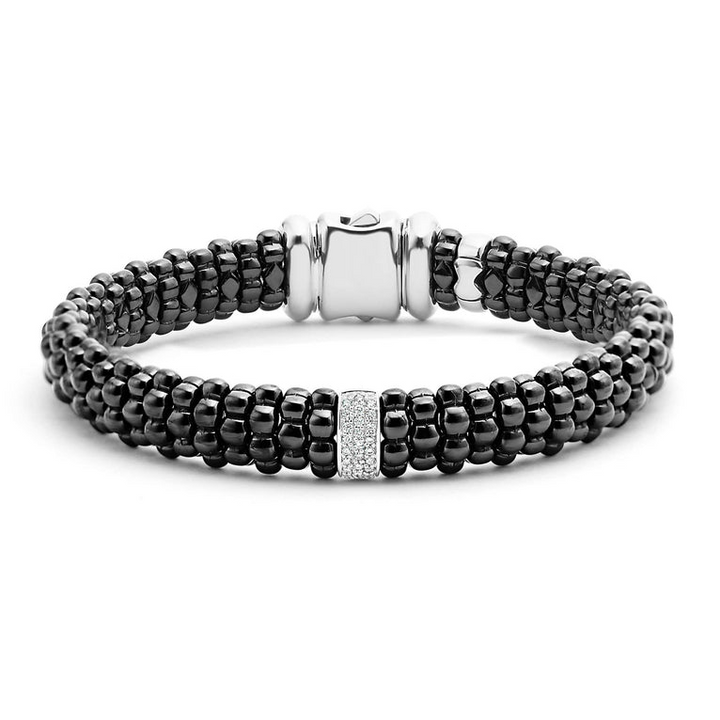 A back-view of a sterling silver bracelet in the middle of a white background featuring diamonds is set in silver and surrounded by black ceramic Caviar beading.