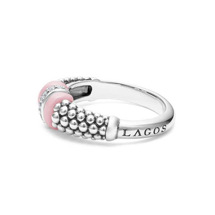 A side-view of a sterling silver ring is displayed on a white background featuring pink ceramic caviar beading with a row of diamonds.