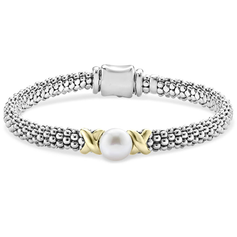 A sterling silver bracelet in the middle of a white background featuring a freshwater cultured pearl framed by two 18K gold x stations