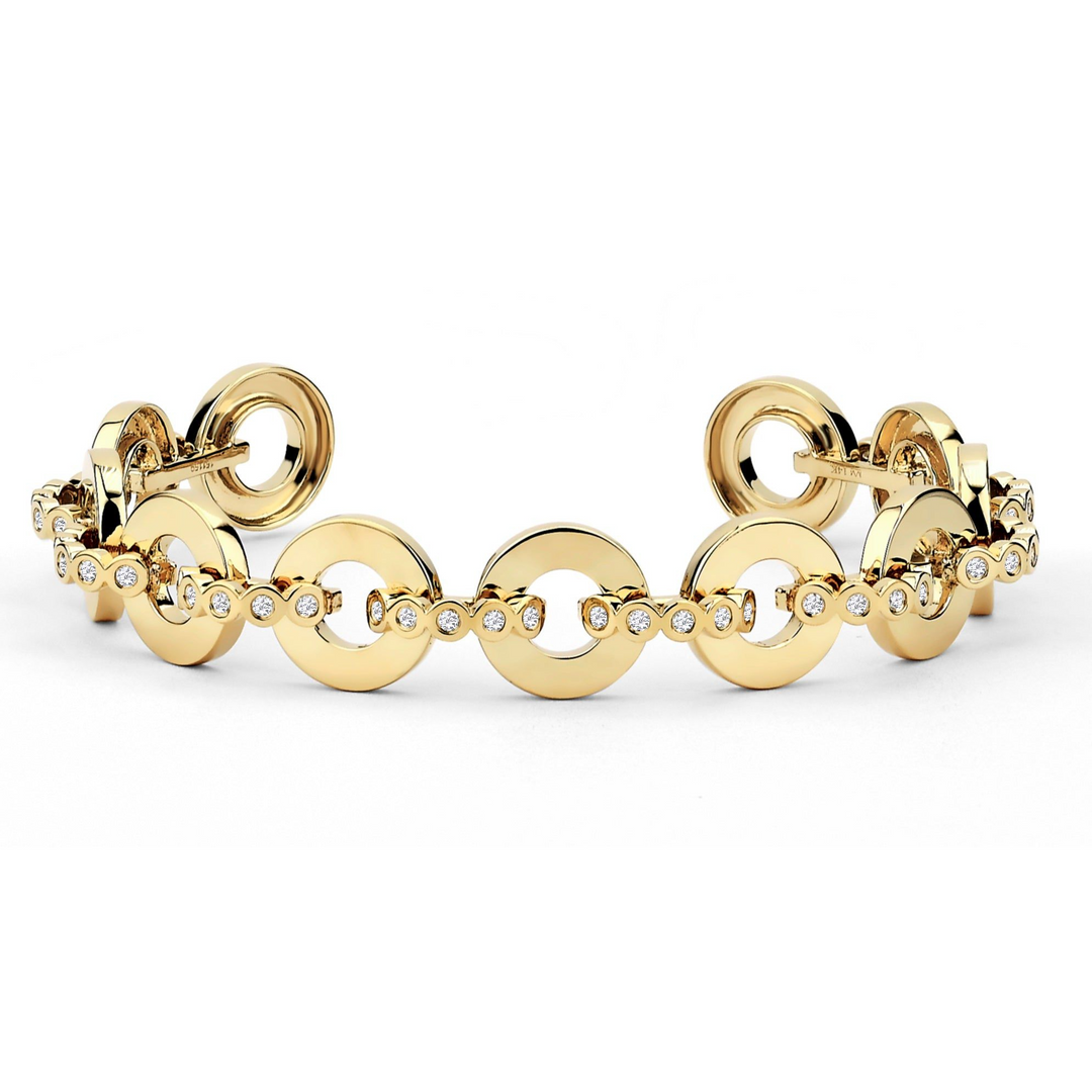 A yellow-gold bracelet lying flat against a white background. The bracelet features bezel-set stones and circle links.