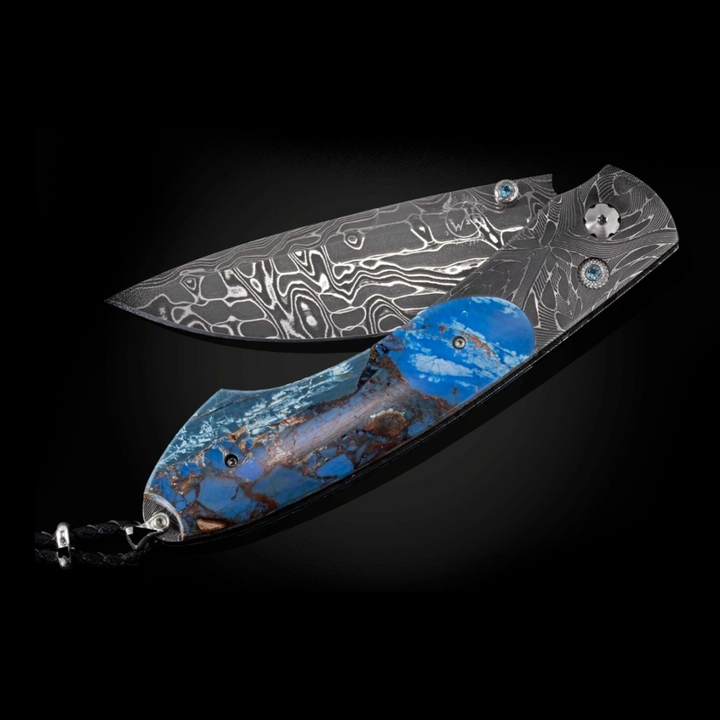 A close-up of a pocket knife with the blade halfway angled to the left. The pocket knife features a hand-forged ‘X-Out’ Damascus frame, inlaid with a mesmerizing scale of ‘Mammoth Fusion', and an ‘Intrepid’ Damascus steel blade.