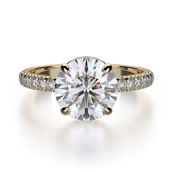 The Hidden Halo Pave Engagement Ring, made of yellow gold, lies flat against a white background. It features a round-cut diamond set in the center with a diamond set band