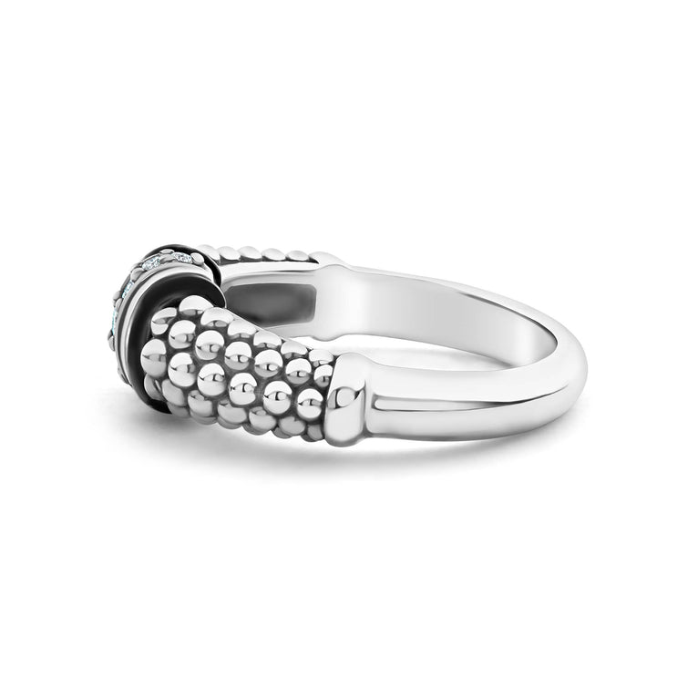 A side-view of a sterling silver ring is displayed on a black background featuring white ceramic caviar beading with a row of diamonds.