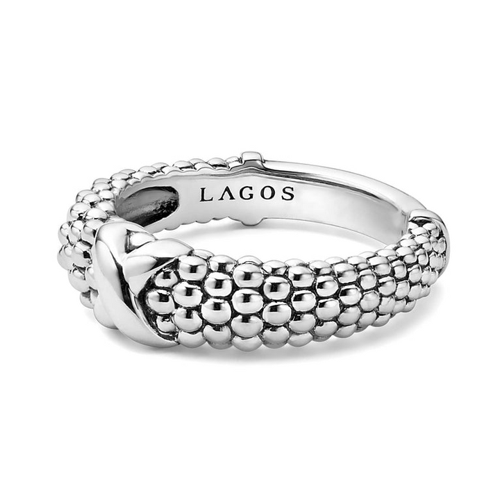 A side-view of a sterling silver ring displayed in the middle of a white background featuring an x motif and silver Caviar beading