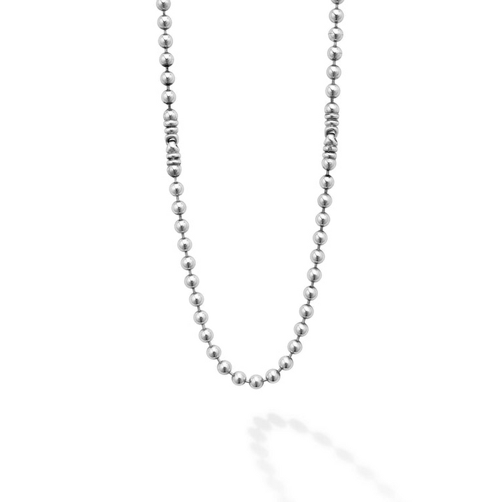 A Sterling Silver & 18K Gold necklace in the middle of a white background, featuring Caviar beading and fluted accents