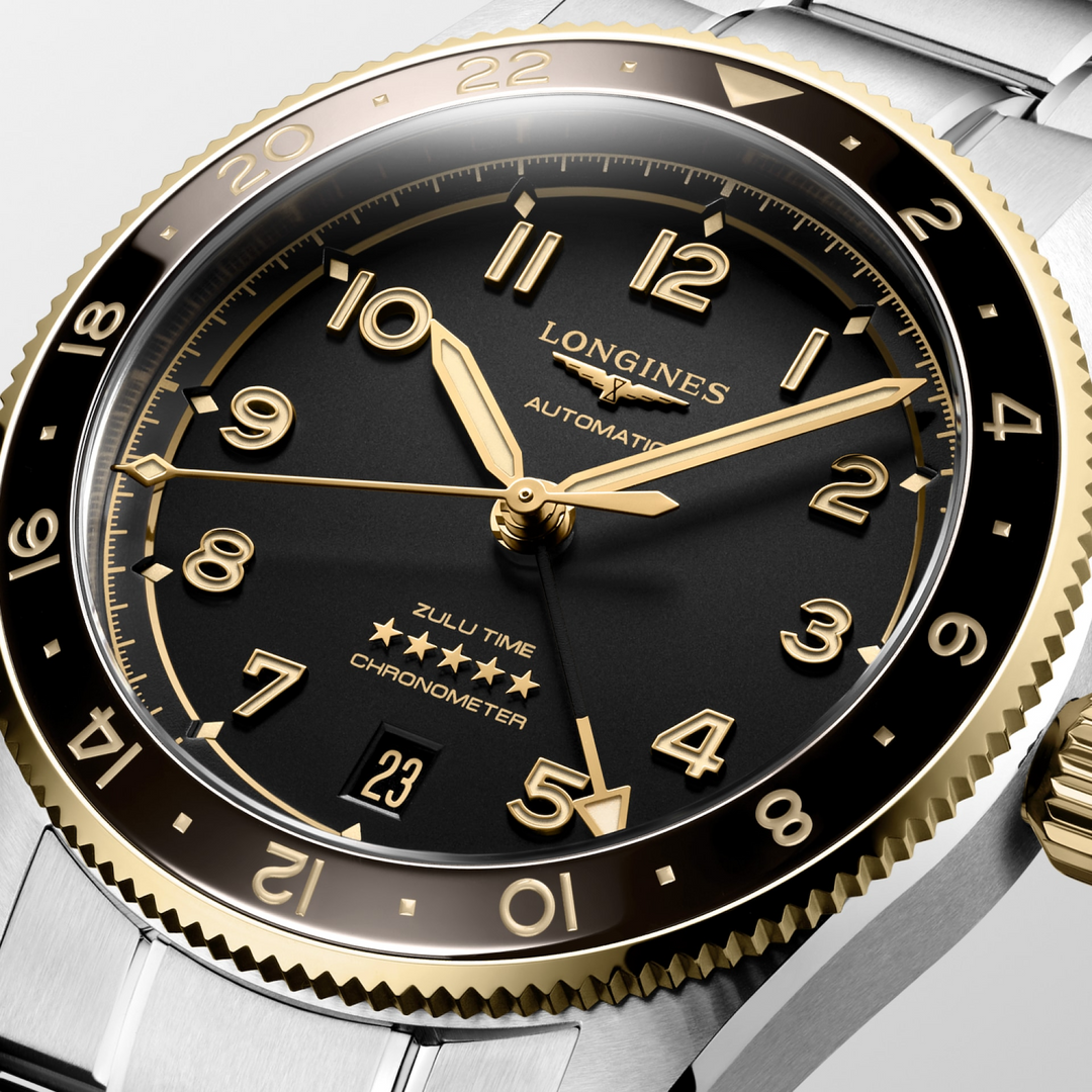 A close-up of a Longines watch highlighting the black dial and crown. 