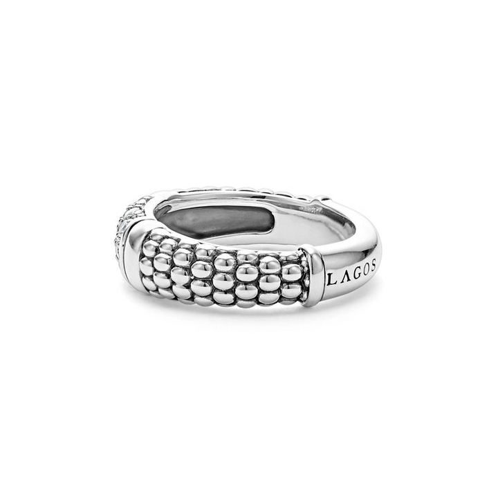 A side-view of a sterling silver ring displayed in the middle of a white background featuring Pavé diamonds and silver Caviar beading