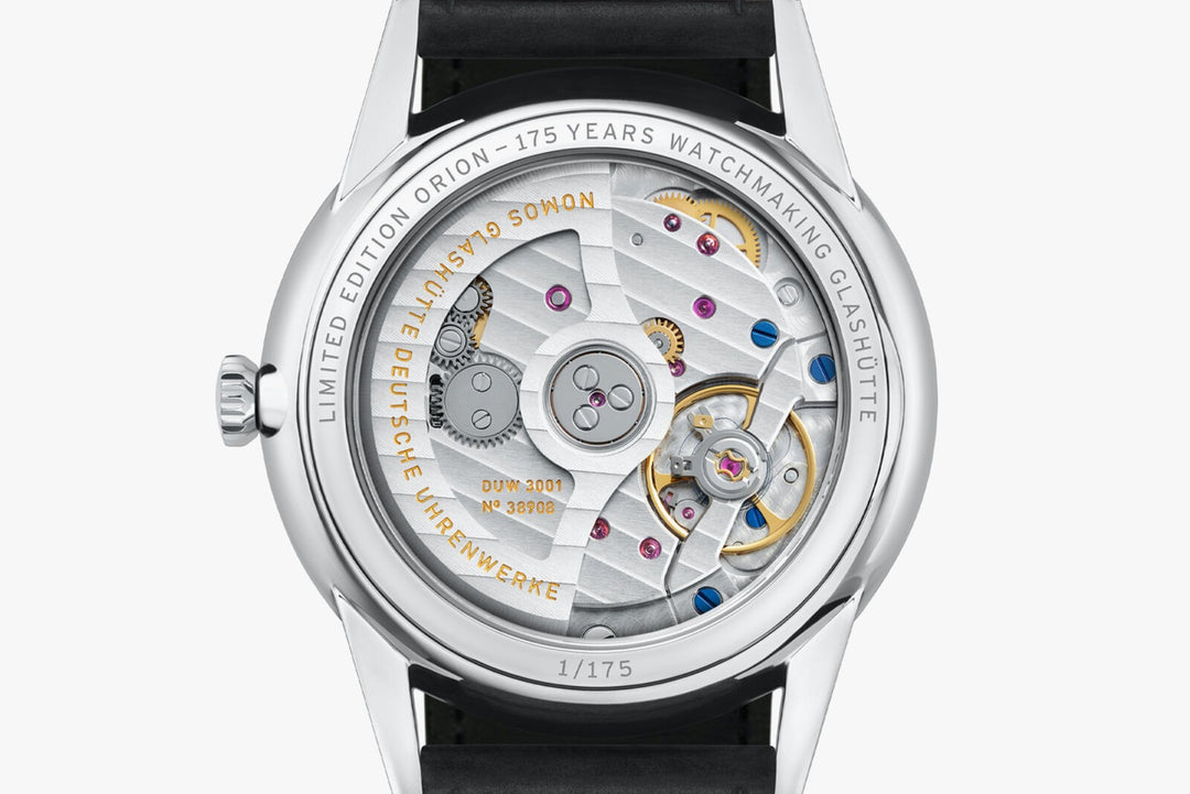 The back of a Nomos Glashutte watch showcases the back of the dial, stainless steel bezel, and strap.