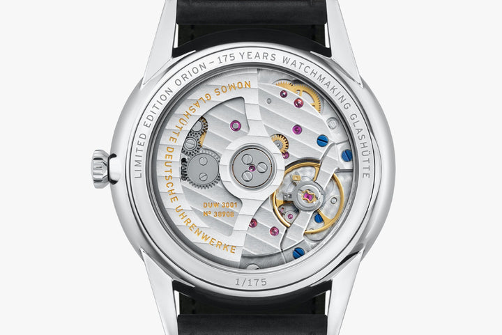 The back of a Nomos Glashutte watch showcases the back of the dial, stainless steel bezel, and strap.