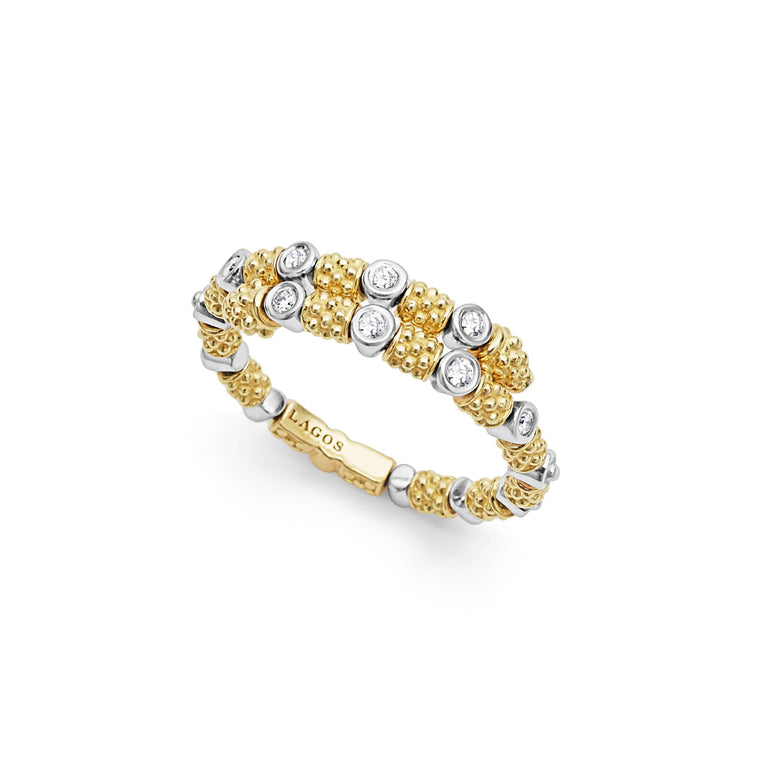 An angled view of a yellow gold ring against a white background. The ring features 18k gold superfine Caviar beading, wrap design, and round diamond stations.