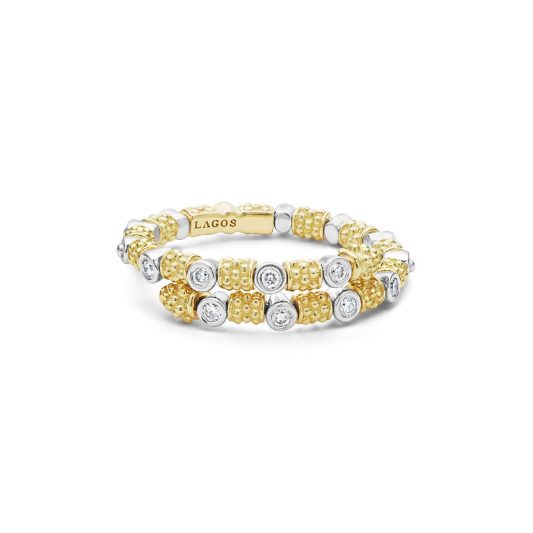 A front view of a yellow gold ring against a white background. The ring features 18k gold superfine Caviar beading, wrap design, and round diamond stations.
