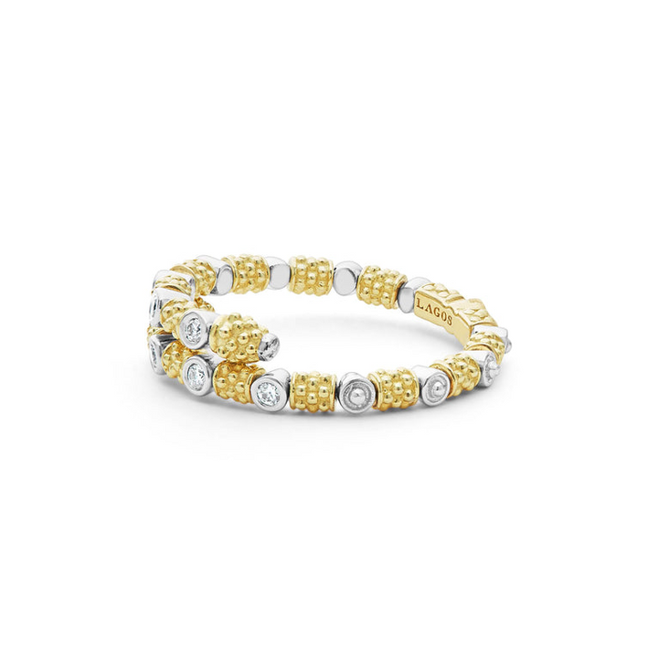 A side view of a yellow gold ring against a white background. The ring features 18k gold superfine Caviar beading, wrap design, and round diamond stations.