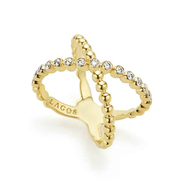 An angled view of a yellow gold ring against a white background. The ring features round-shaped diamonds set in 18K gold beading, forming the signature LAGOS X ring.