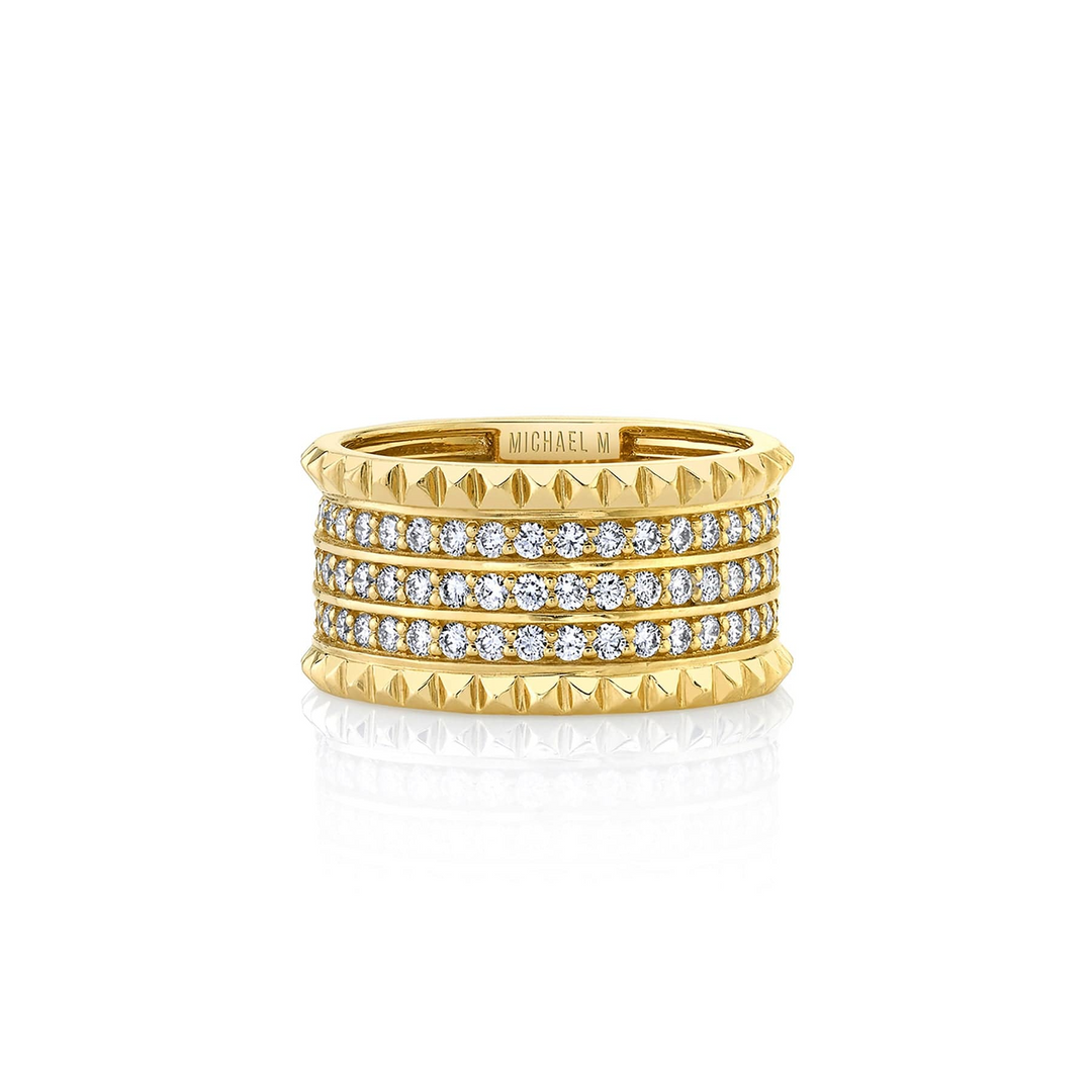 A yellow-gold bracelet lying flat across a white background. It features three rows of pave-set round diamonds between two bands of miniature pyramid studs.