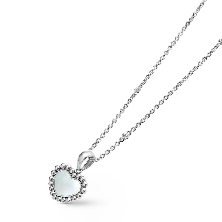 A sterling silver necklace angled to the right featuring a heart-shaped mother of pearl gemstone pendant framed by sterling silver Caviar beading