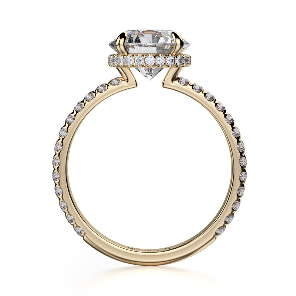 A side-view of the Hidden Halo Pave Engagement Ring, made of yellow gold. The side view shows the diamond's pavilion and the whole yellow gold band. Showing the "Michael M" inscription is visible inside the band at the bottom.