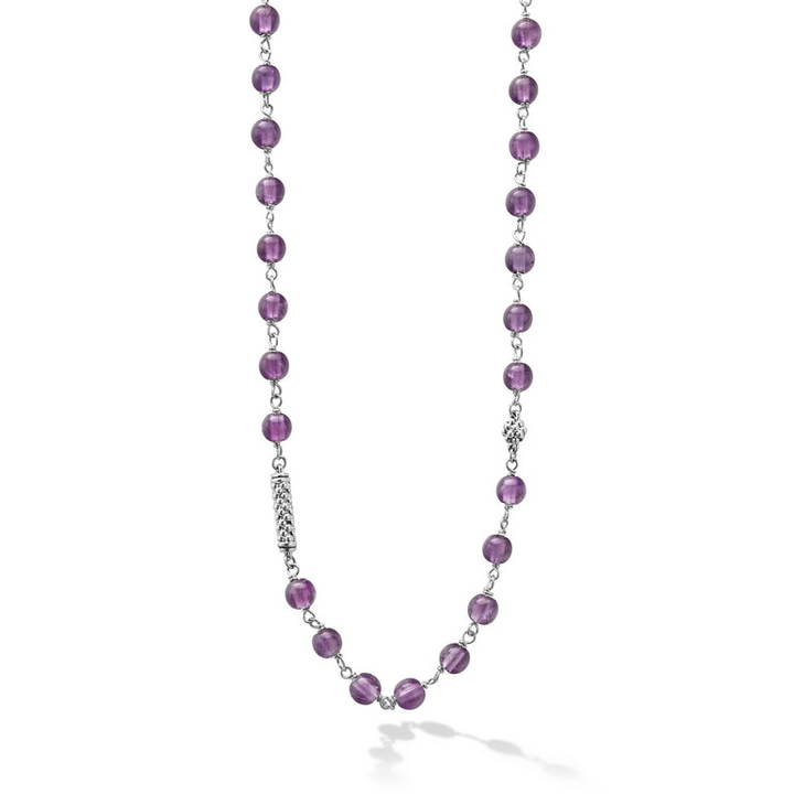 A close-up of a sterling silver and ceramic beaded necklace in the middle of a white background featuring Amethyst ceramic and silver Caviar beading.