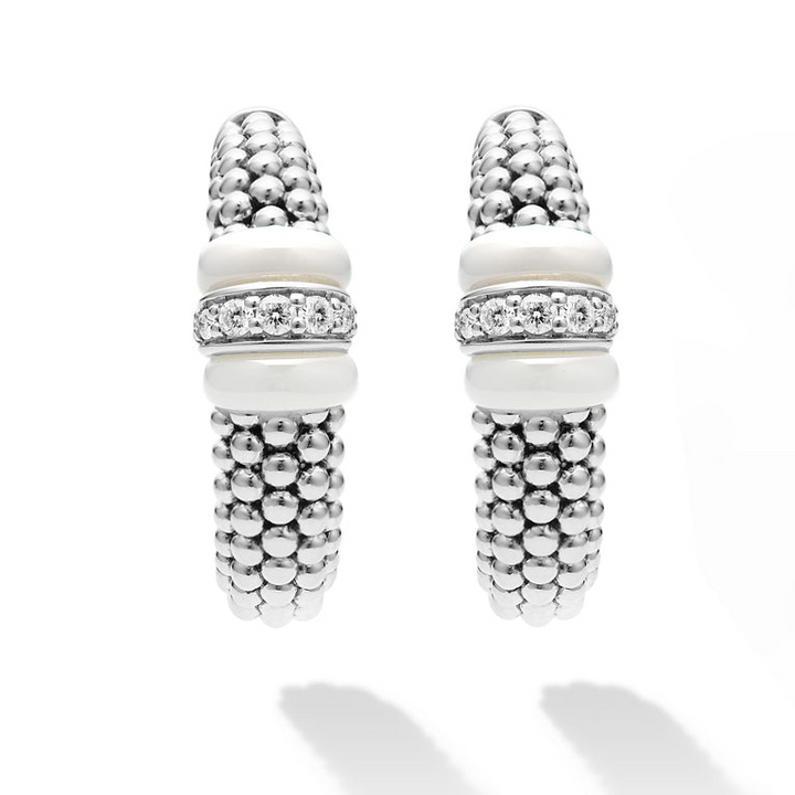 A pair of hoop earrings with white ceramic and a diamond station with sterling silver Caviar beads. The right earring is angled to the side, showing the back.