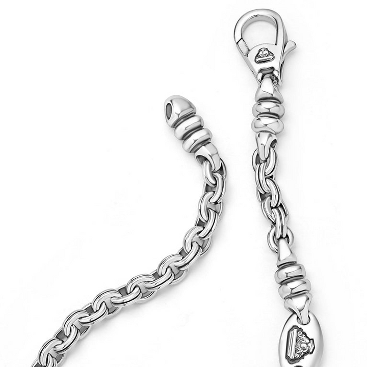 A sterling silver link bracelet angled in the middle of a white background focusing on the clasp, featuring Sterling silver fluted links