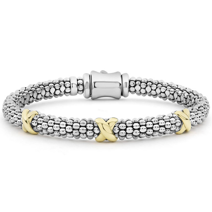 A sterling silver bracelet in the middle of a white background featuring Caviar beading accented by three 18k gold x stations