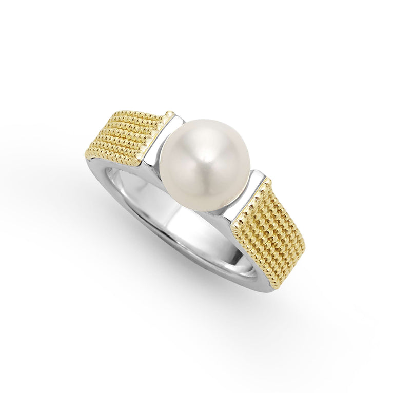 A sterling silver and 18k gold ring displayed angled in the middle of a white background featuring a cultured freshwater pearl and caviar beading. 