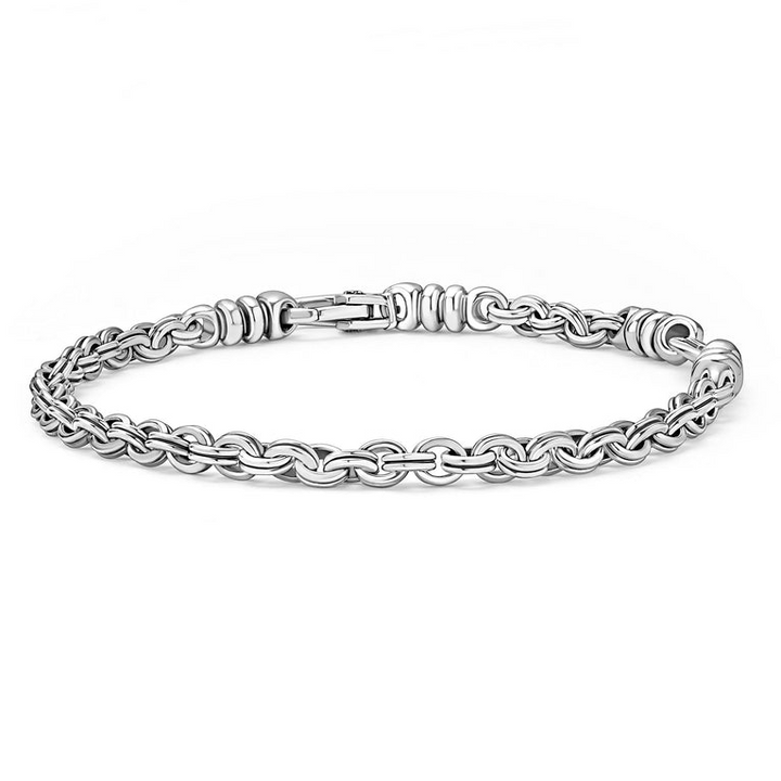 A sterling silver link bracelet angled in the middle of a white background featuring Sterling silver fluted links