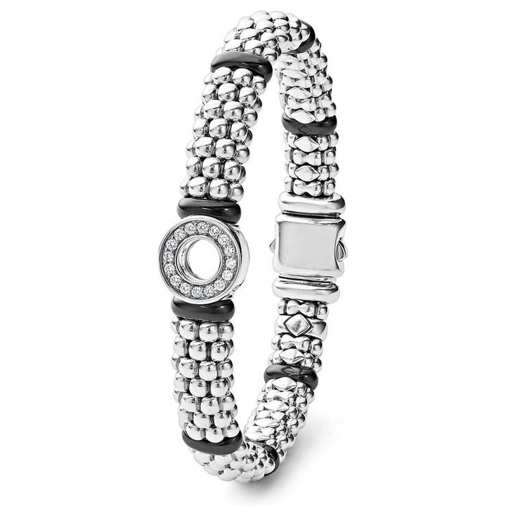 A sterling silver bracelet standing verticality in the middle of a white background featuring smooth black ceramic and diamonds in a circle motif with Caviar beading 