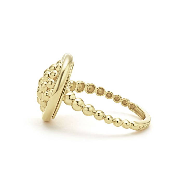 A side-view of An 18K Gold ring in the middle of a white background featuring caviar beading and smooth gold detailing.