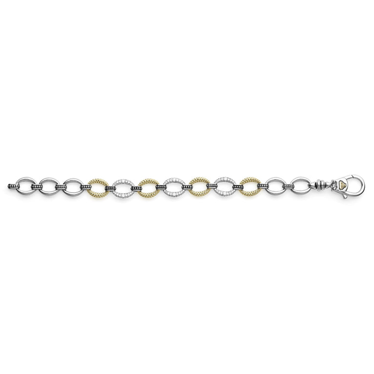 A Sterling Silver & 18k gold bracelet laid out unclasped in the middle of a white background. The bracelet has pave diamond links and a signature lobster clasp. 