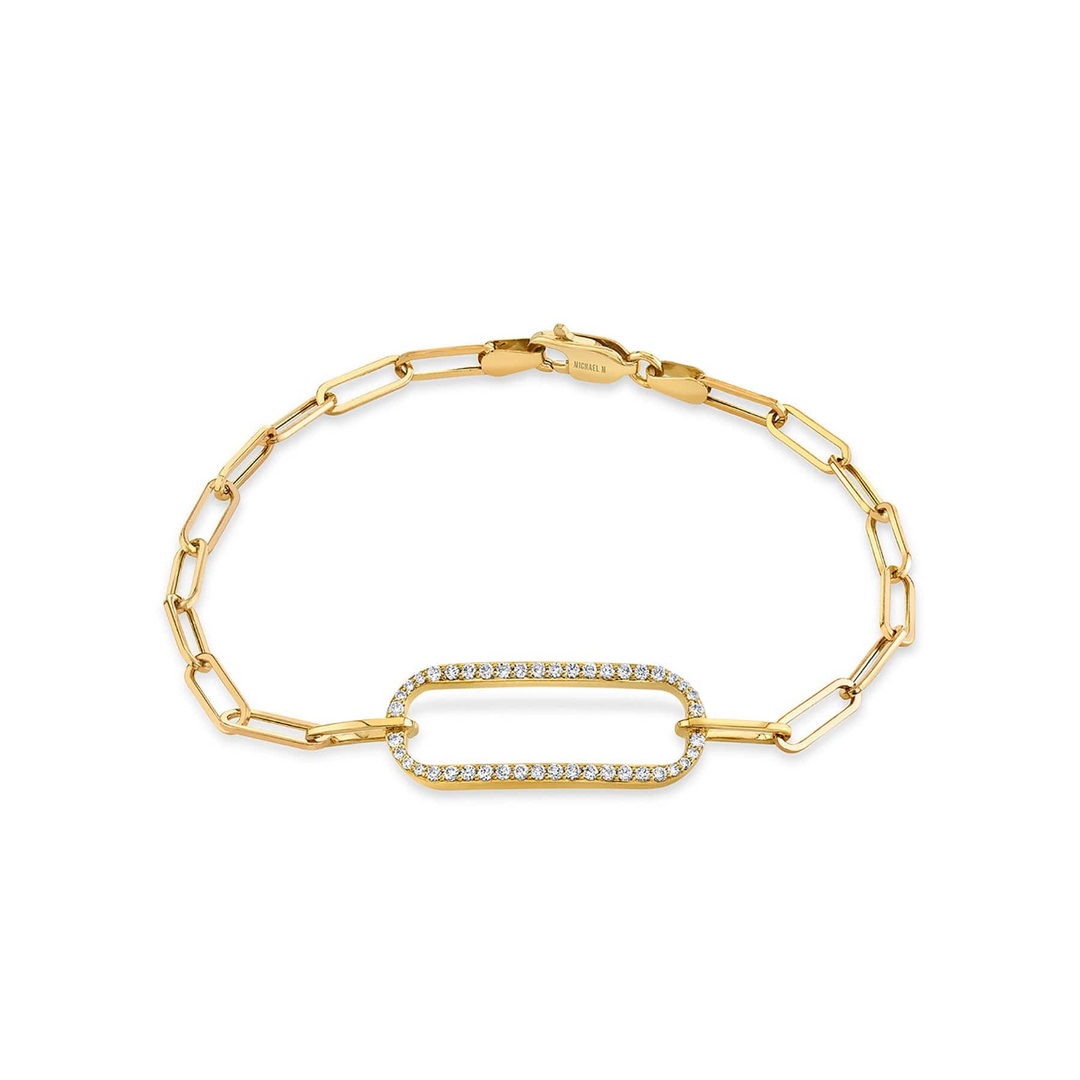 A yellow-gold bracelet lying flat against a white background. The bracelet features a pave link focal element with a pave set of round diamonds and a paperclip link cable chain.