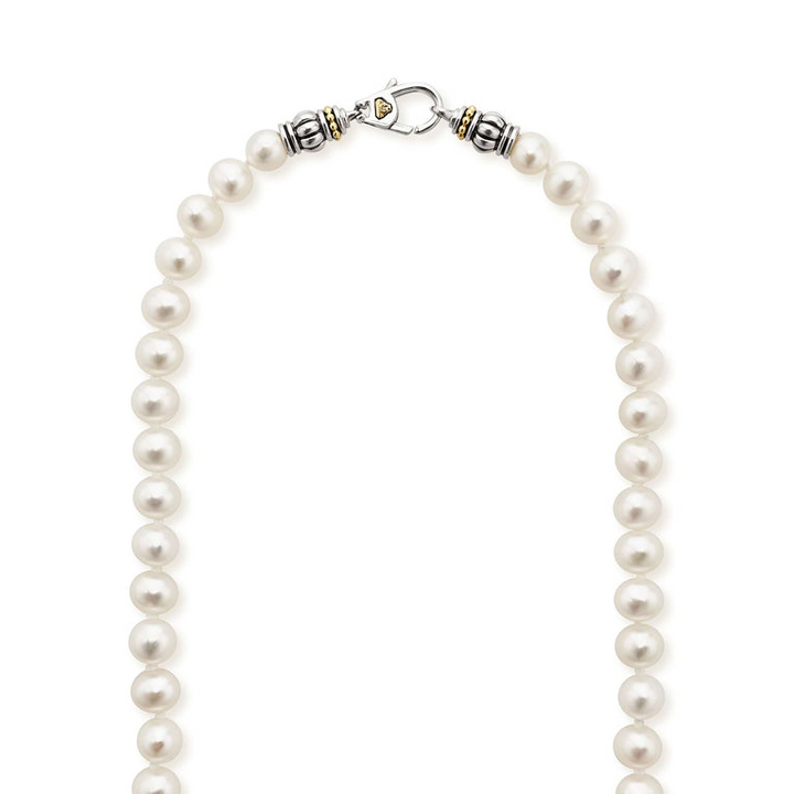 A close-up of a pearl necklace highlighting the clasp.