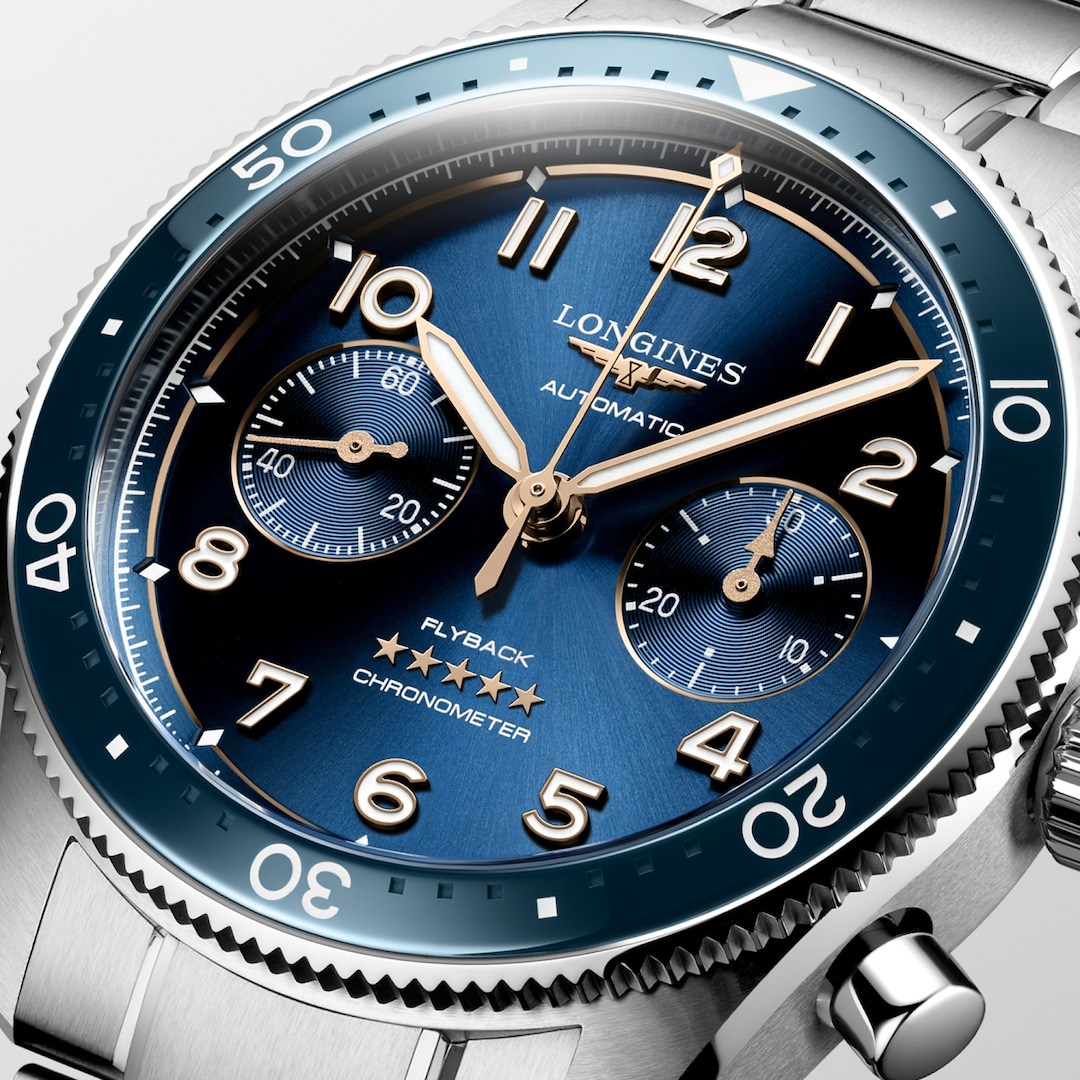 A close-up of a Longines watch highlighting the black & blue dial and two crowns. 