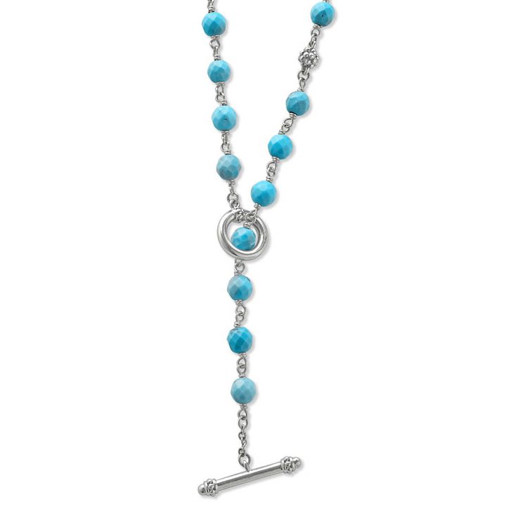 A sterling silver and ceramic beaded necklace in the middle of a white background featuring Turquoise ceramic and silver caviar beading highlights the lobster clasp.