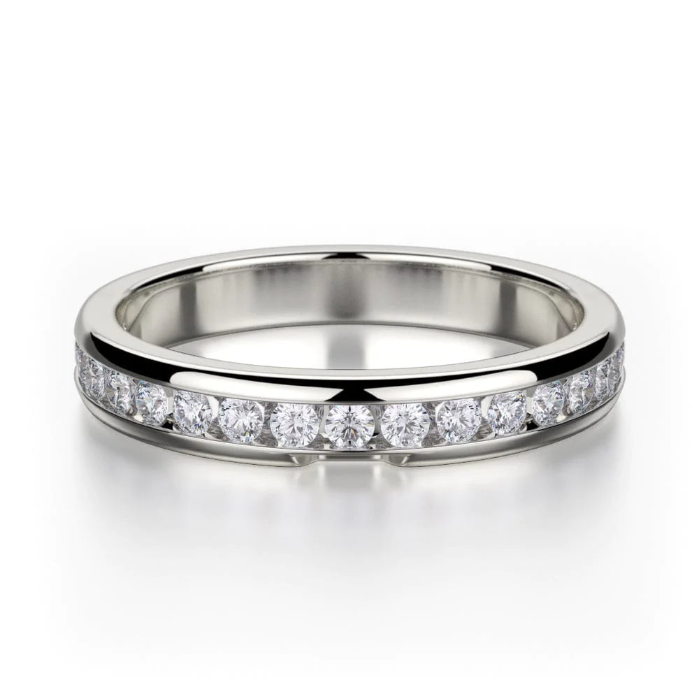 A white-gold ring lies flat against a white background. It features a bezel set of round diamonds.