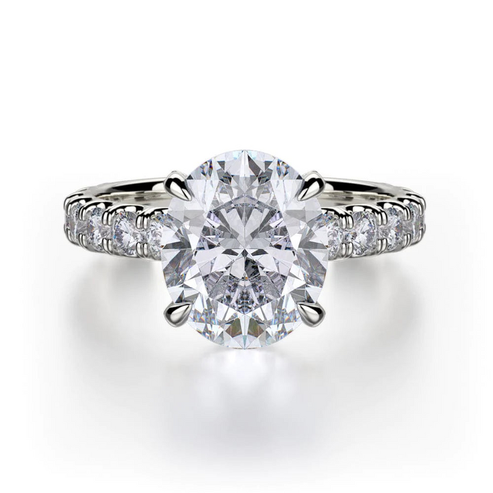 The 3/4 Eternity Engagement Ring, made of white gold, lies flat against a white background. It features a large oval-cut diamond set in the center and a round diamond-set band in a pave setting. 