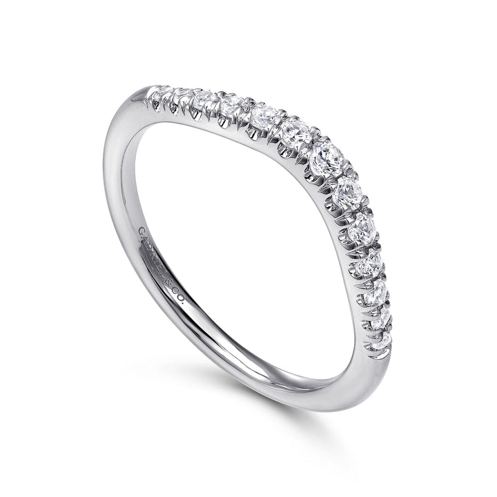 This is a close-up of a white gold ring angled to the right. It shows the inside of the band against a white background. The curved band features round diamonds with a shared prong. 