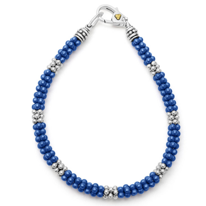 A Sterling Silver & 18K Gold bracelet in the middle of a white background, featuring seven sterling silver stations and ultramarine caviar beading