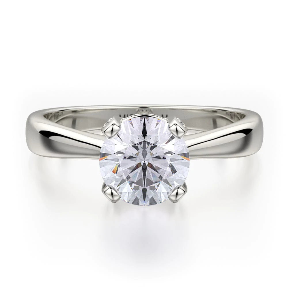 The Pave Diamond Basket Engagement Ring, made of white gold, lies flat against a white background. It features a round-cut diamond set in the center.