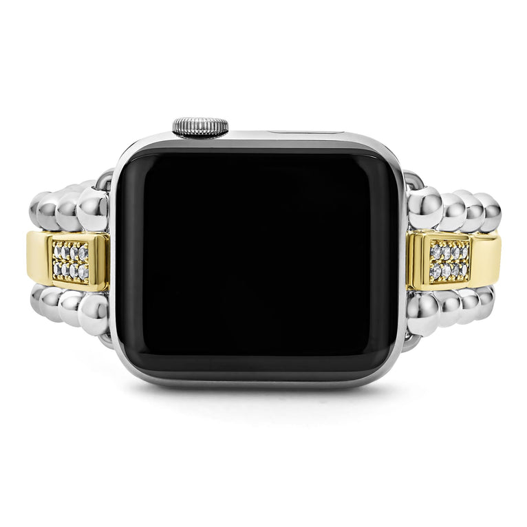 An Apple watch rests in the middle horizontally against a white background, showcasing the Apple watch face. The watch band features 18K gold-stationed links and stainless steel beading around the links.